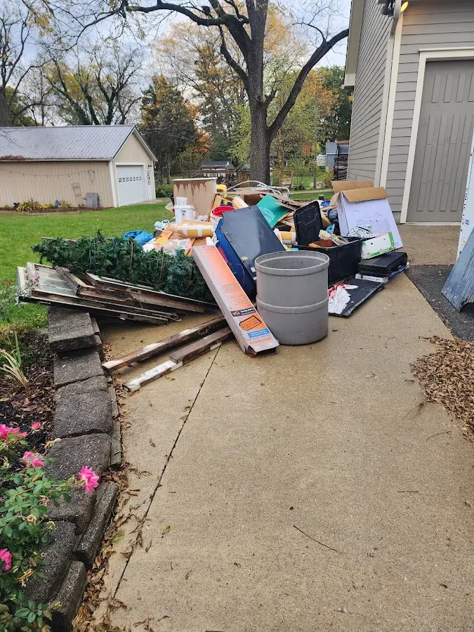 Dumpster being loaded with debris for Commercial Dumpster Rental in East Brunswick